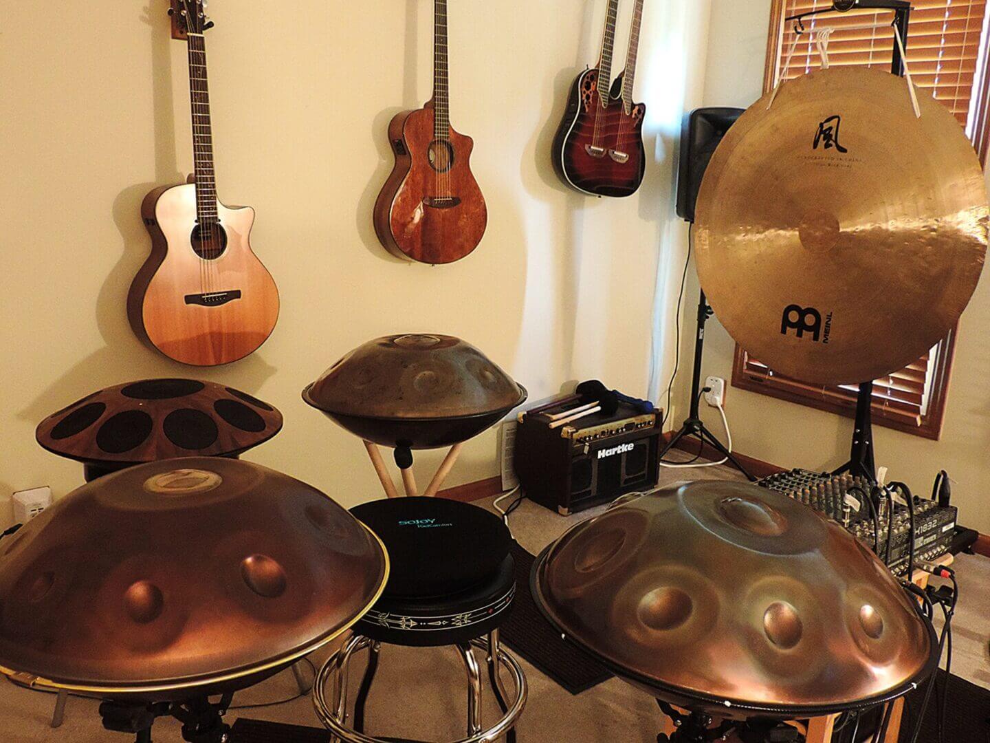 A collection of percussion and string instruments in a cozy music room.
